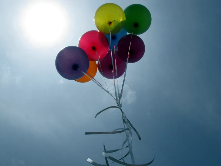 balloons with ribbons stuck to the bottom of them