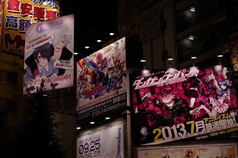 a large number of posters on the side of a building