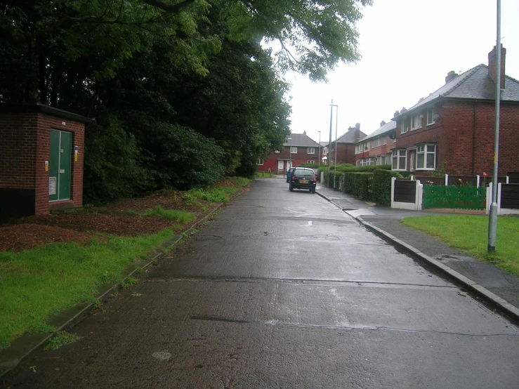 cars are parked on a road near some trees