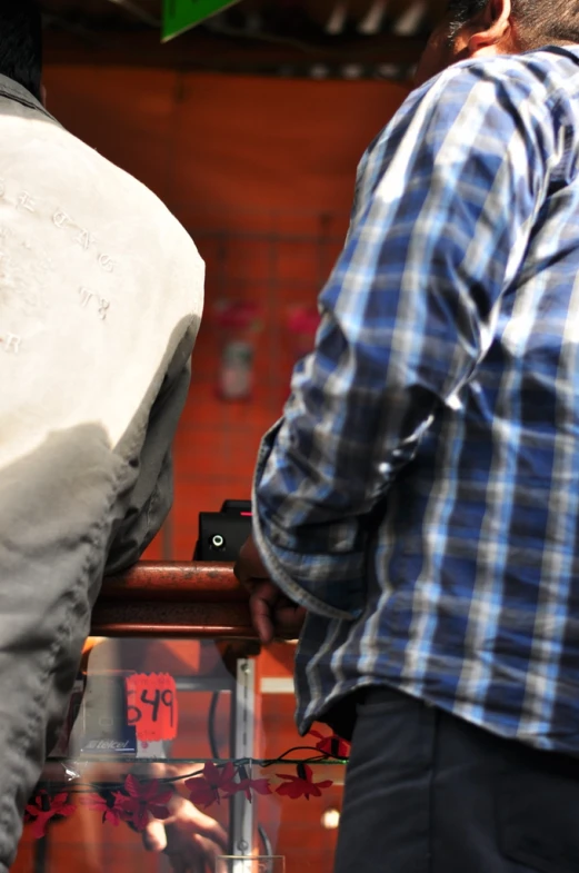 two people are looking through a glass container