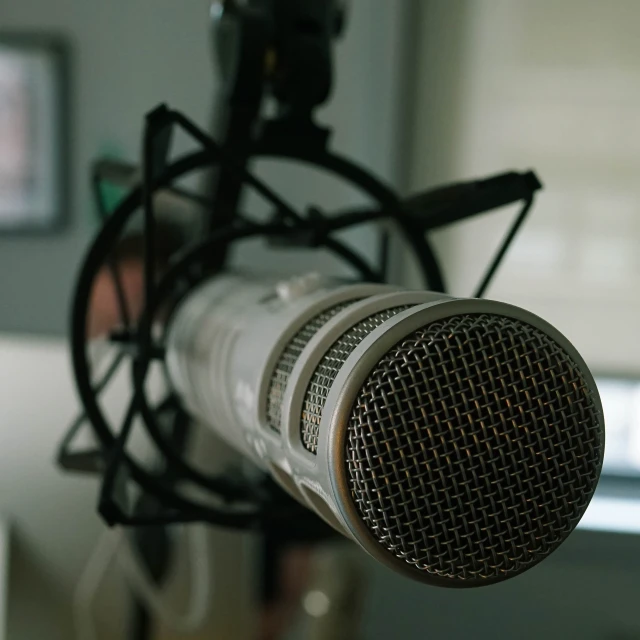 a microphone mounted in to a wall next to a laptop computer