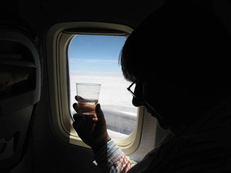 a man is taking a picture from a plane window