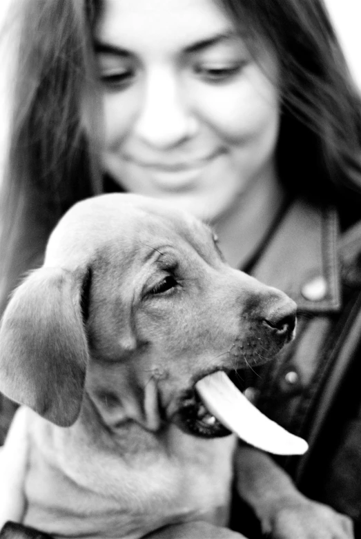 a woman holding her dog and posing for the camera