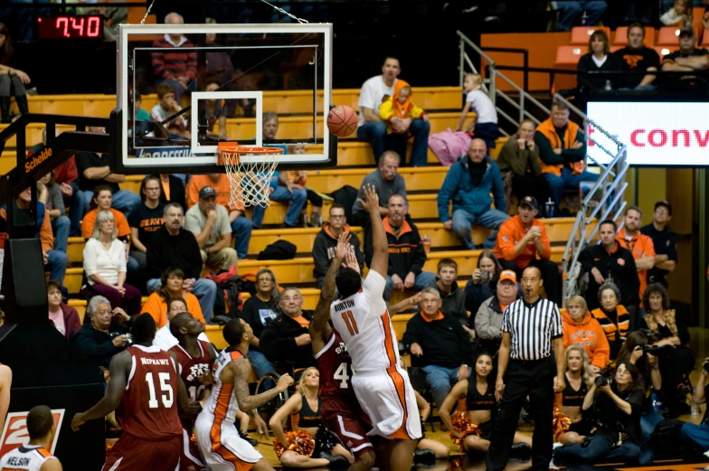 two men basketball players in mid air at a game