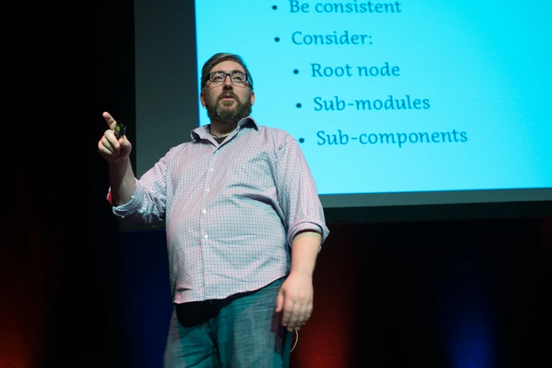 a man pointing at soing and presenting on a screen