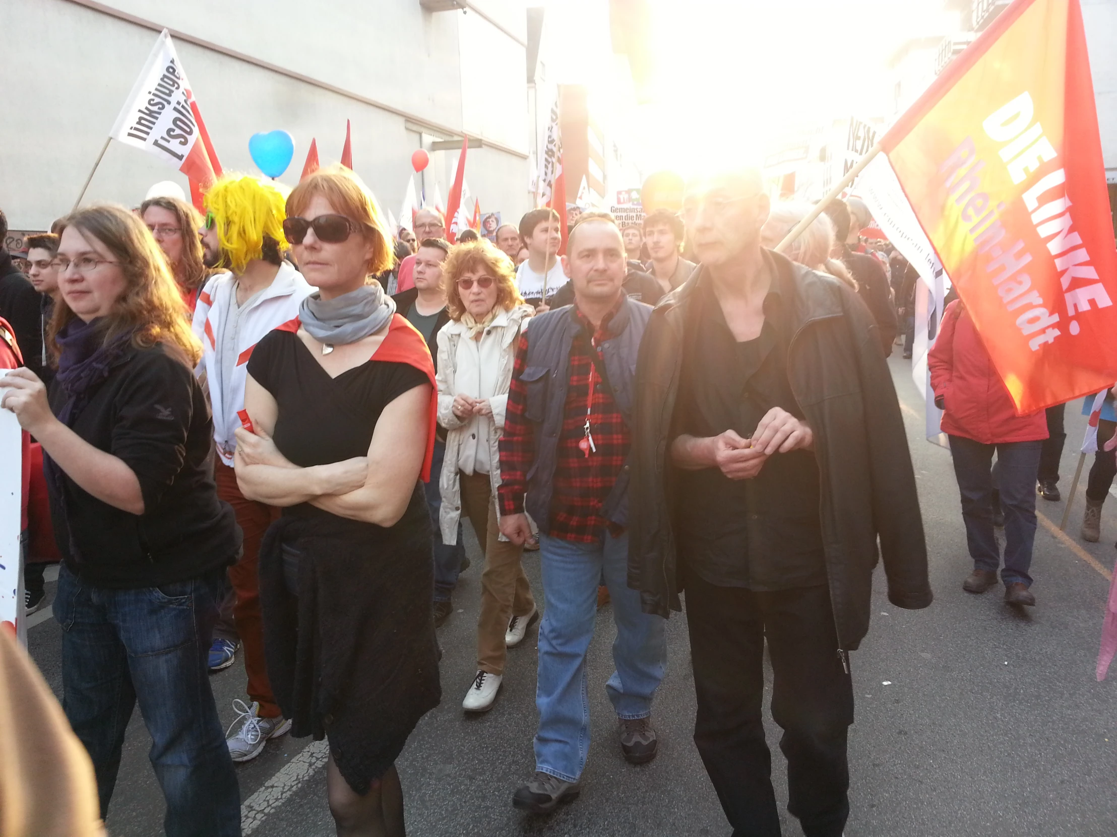 people walking in the street holding signs