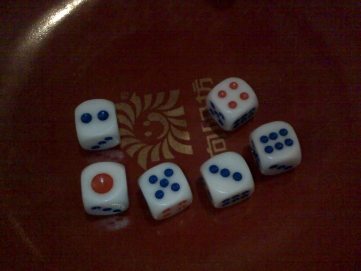 four dices arranged in a pattern sit on top of a table