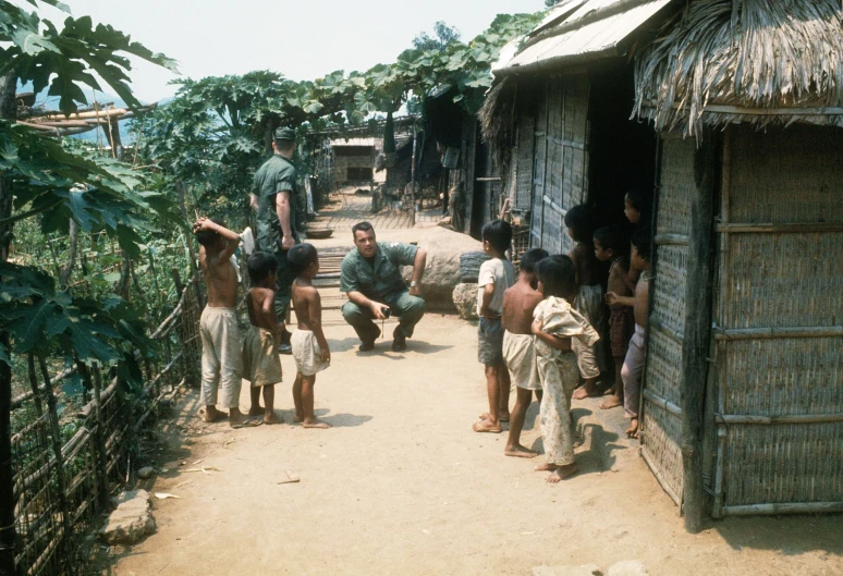 a group of people standing around outside of shacks