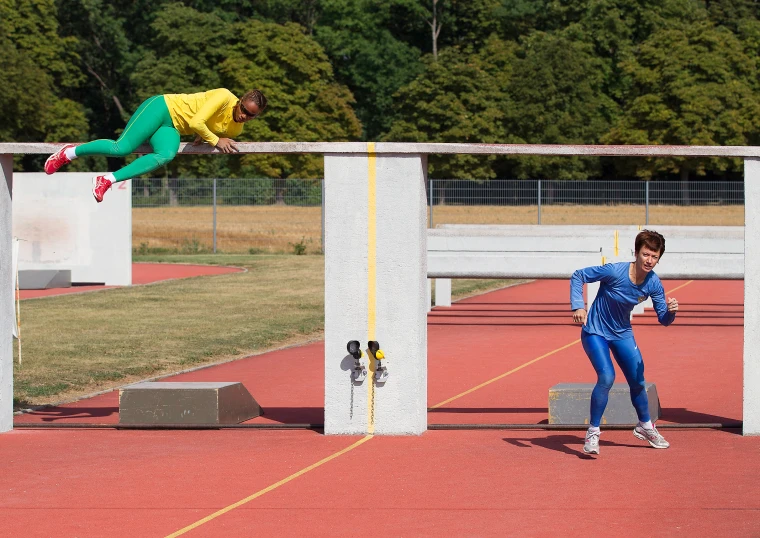 a woman jumping over obstacles during an event