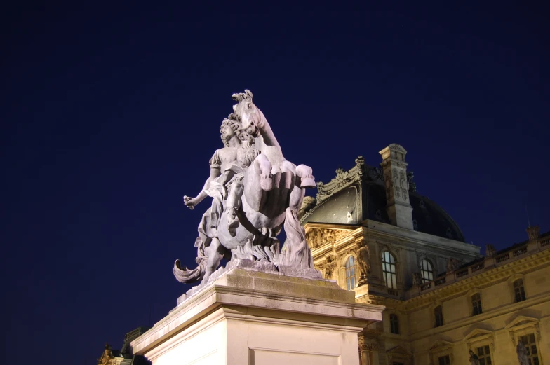 the top of a statue shows the city's skyline