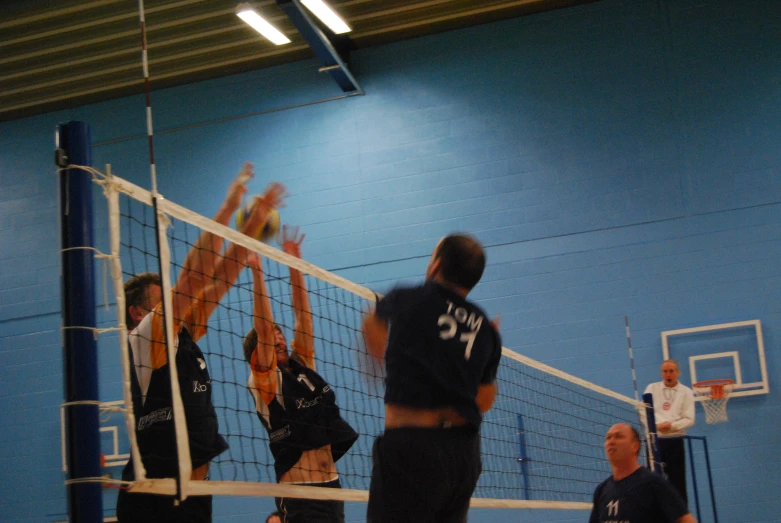 volleyball players are attempting to block the ball