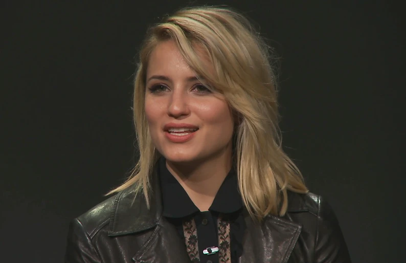 a woman smiling with a dark background