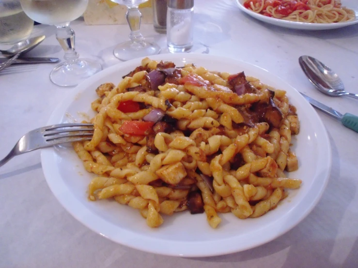 pasta with onions and tomato on a plate