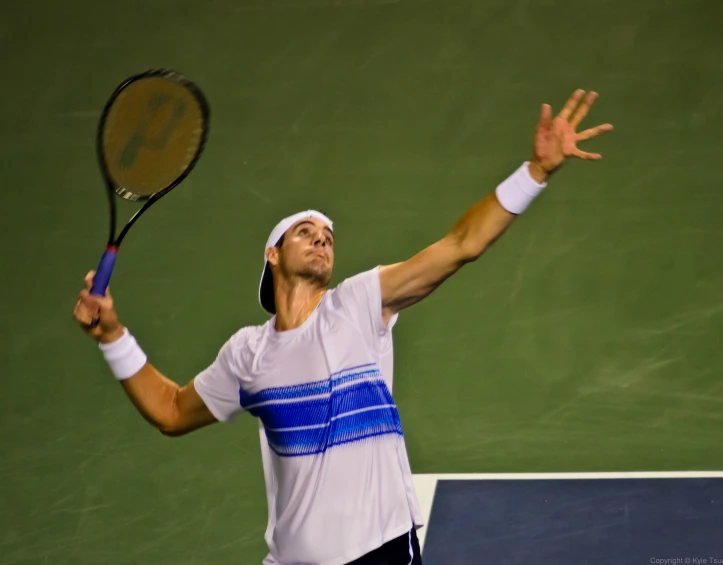 a man is reaching out with his tennis racket