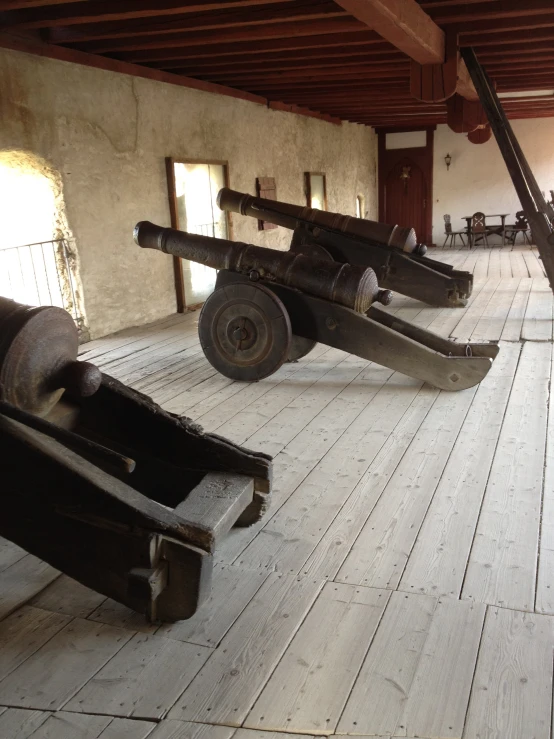 some type of gun sitting on the floor in a museum