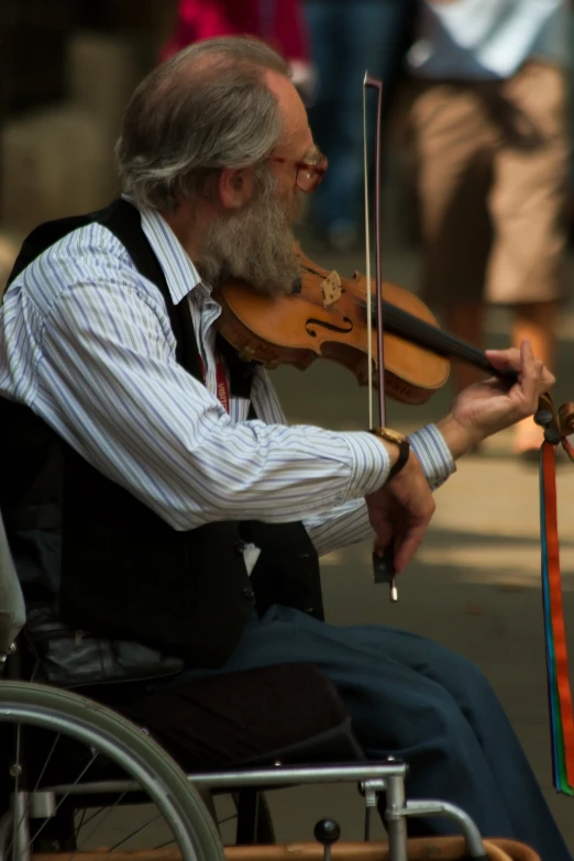 a man playing the violin with a person holding one