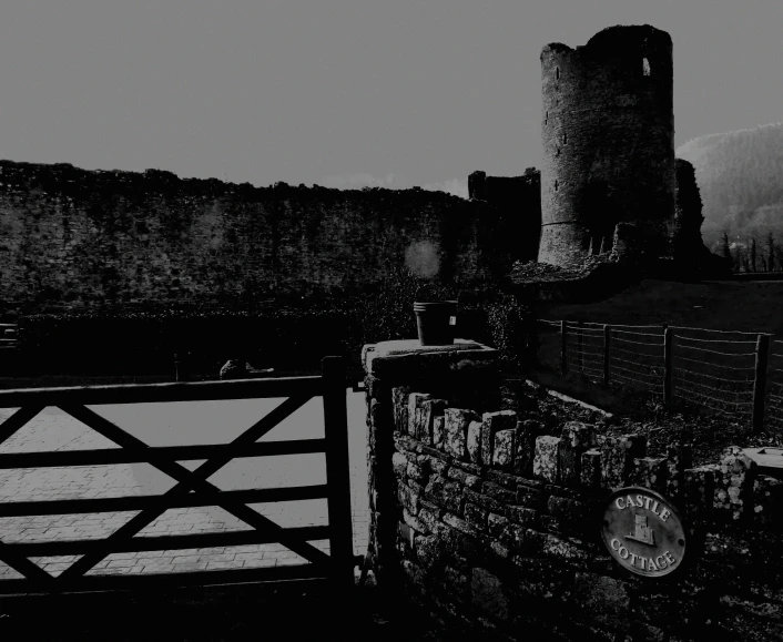 black and white pograph of a gate and a tower