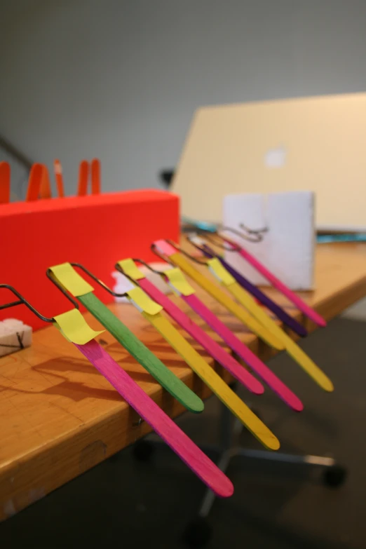 several colorful pairs of toothbrushes on top of a table