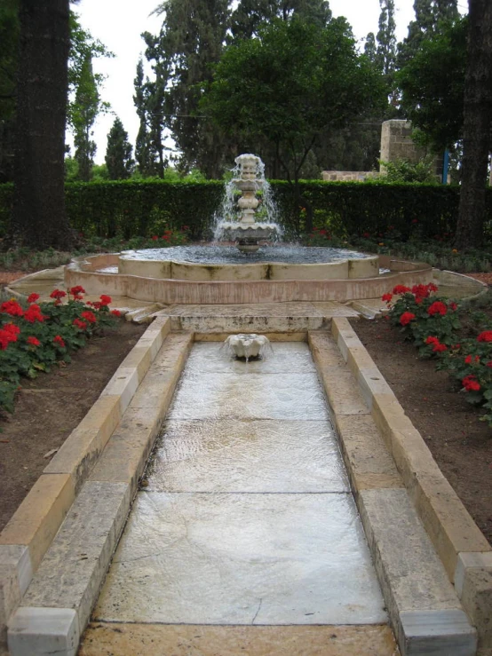 a statue and a garden on a sunny day