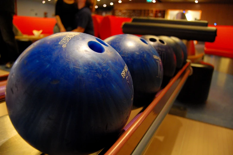 a number of bowling balls sitting on a line