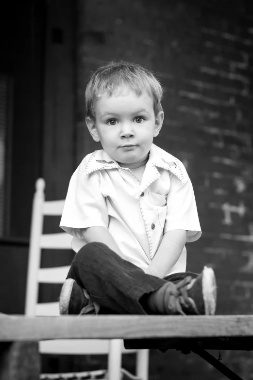 a  sitting on top of a wooden chair