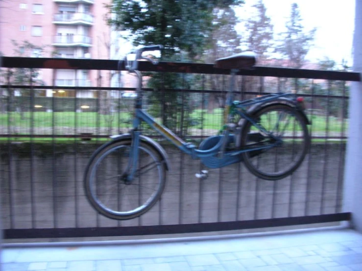 a bike locked up to a fence on the street