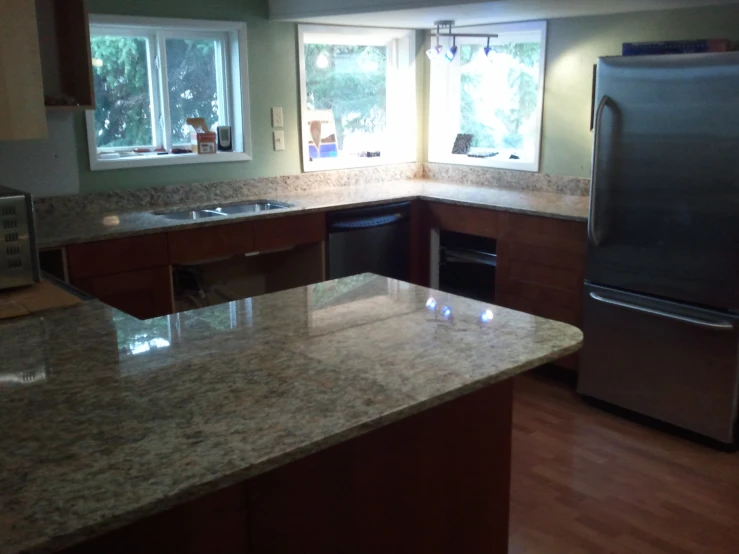 a kitchen with an oven, refrigerator and sink