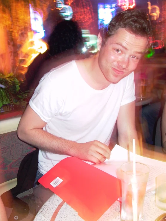 a man sitting at a table with drinks