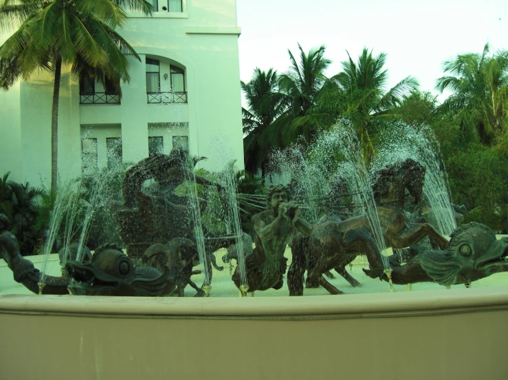 three water fountains with horses in it