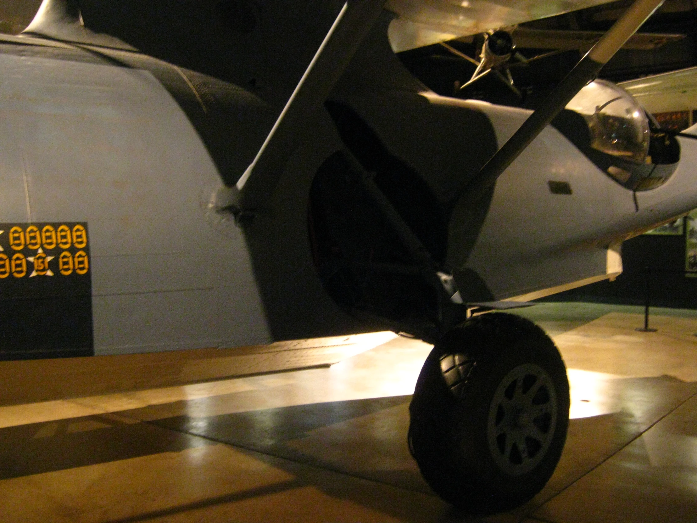 an airplane is sitting in the museum, with it's propellers down