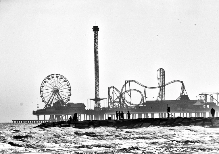 a couple of men stand on the end of a pier