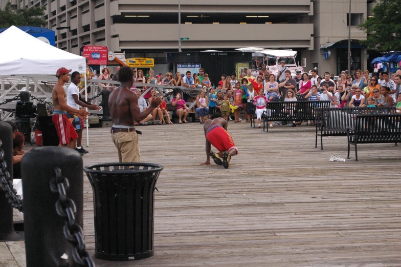 a man on a skateboard is performing tricks for a crowd