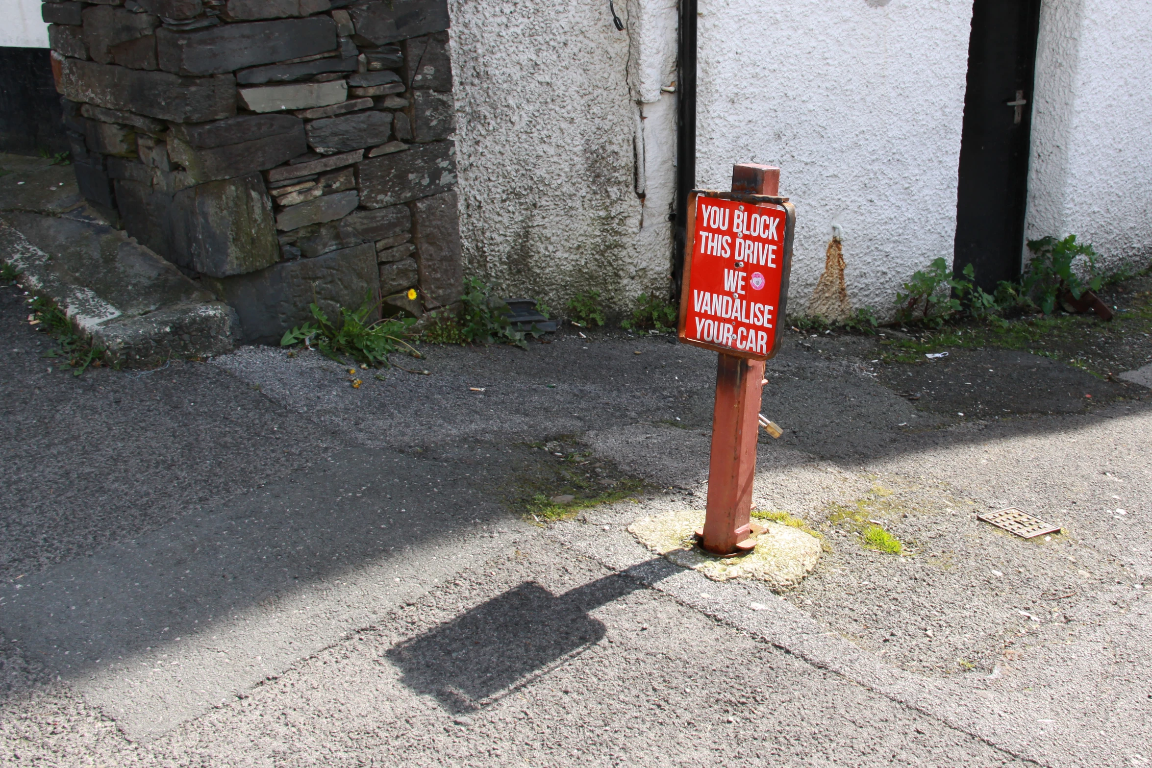 a sign that is on the ground near a sidewalk