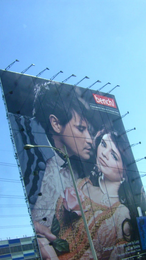 billboards on building facade with a man and woman looking at each other