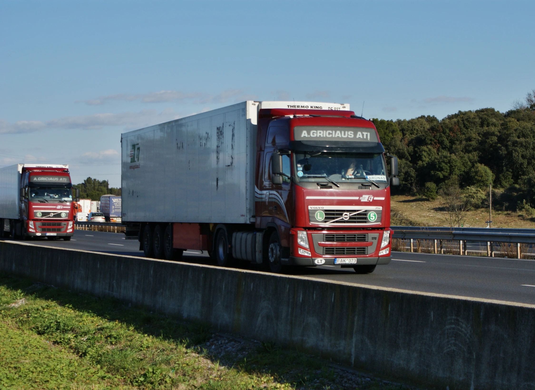 a couple of trucks are on a highway