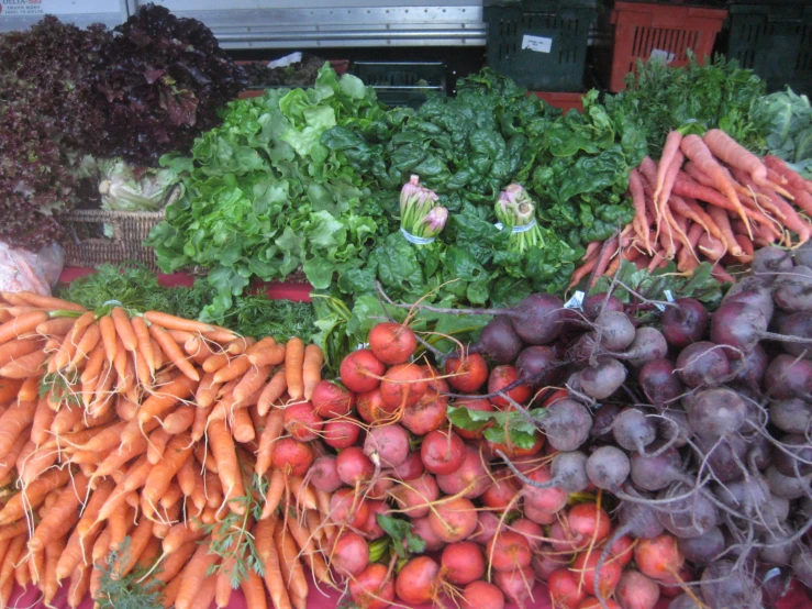 fruits and vegetables are displayed for purchase at a market