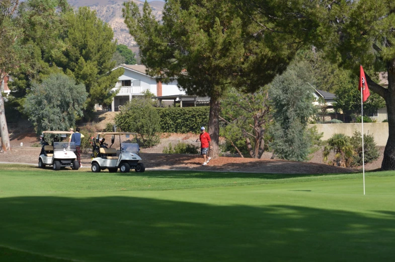 a golf club with a couple of players on the field