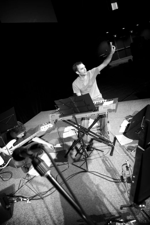 a man recording in front of some microphones