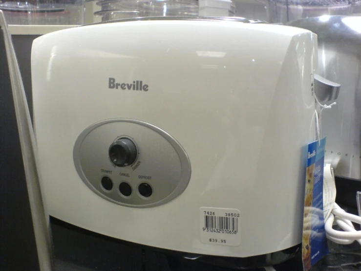 an electric coffee maker is on display with other items