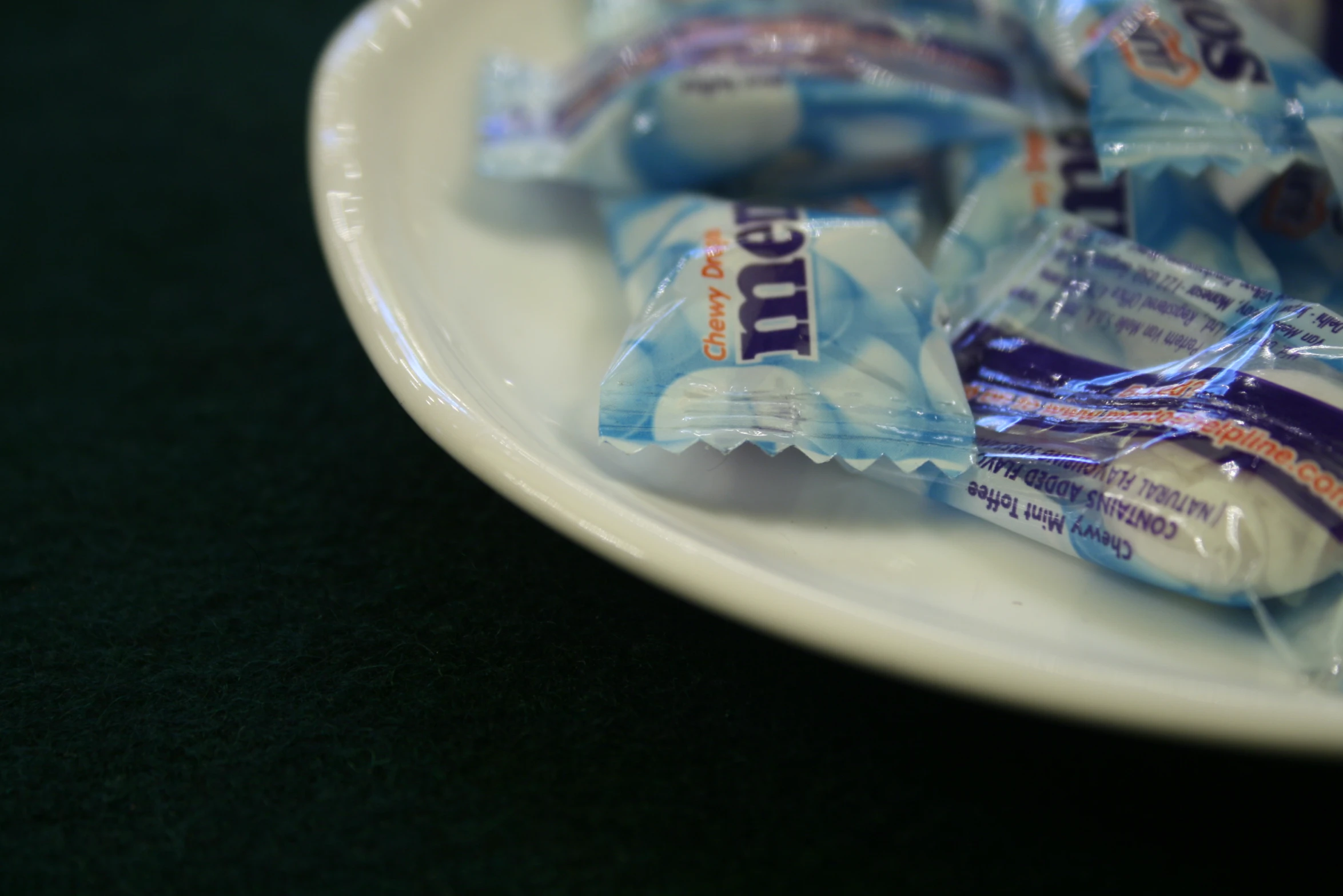 some hers chocolates are sitting on a white plate