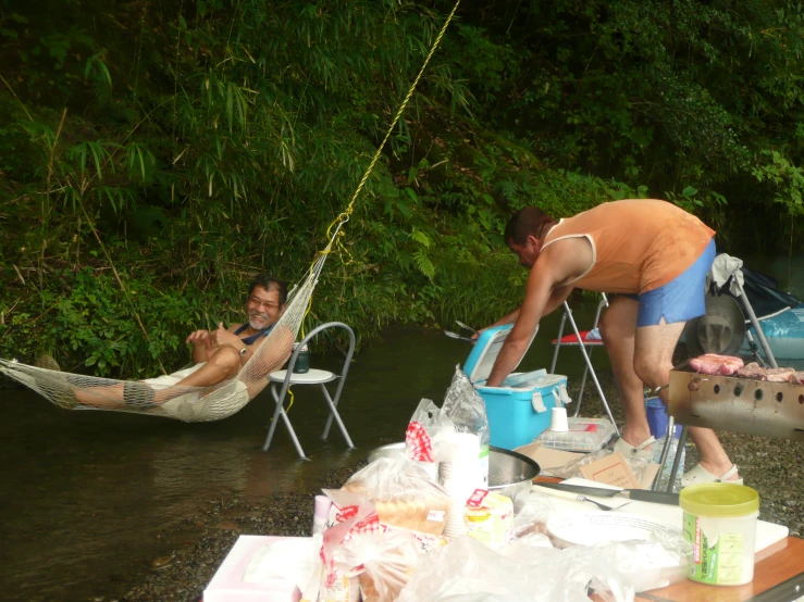 man on a raft picking up a hammock