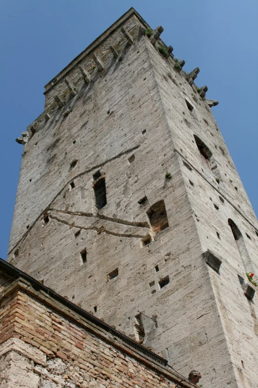 a tall stone tower has several windows