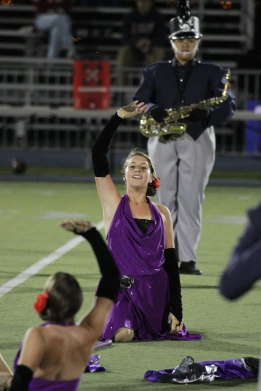 a female in purple is on the ground with another woman in black and silver