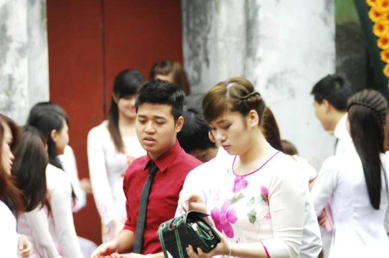 a man and woman standing in front of others