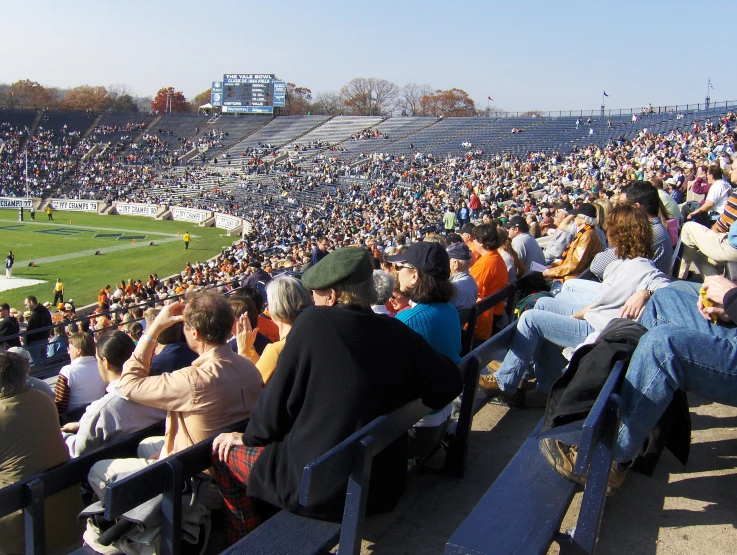 a huge crowd of people in seats watching a game