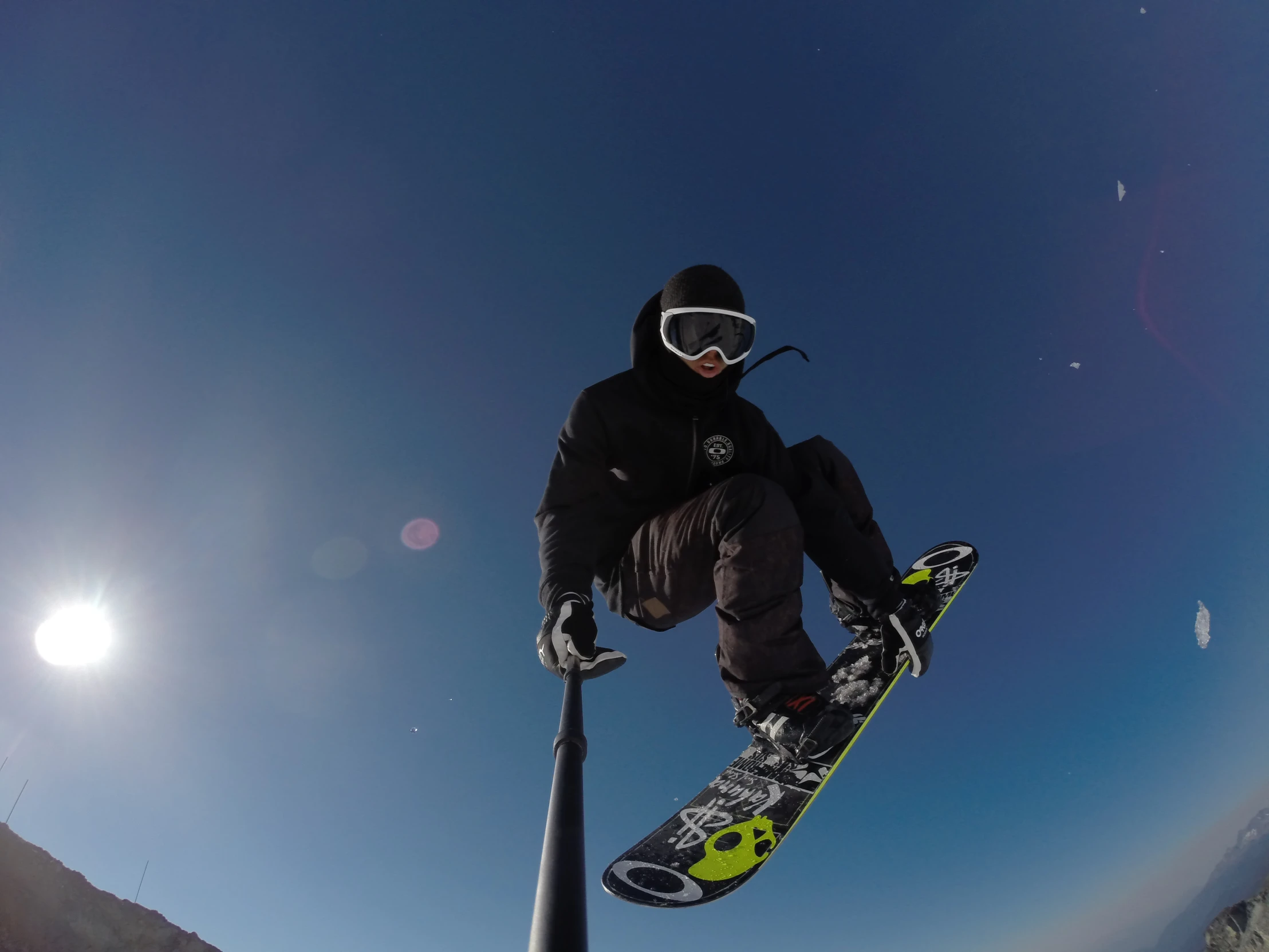 snowboarder on the side of a pipe while doing trick