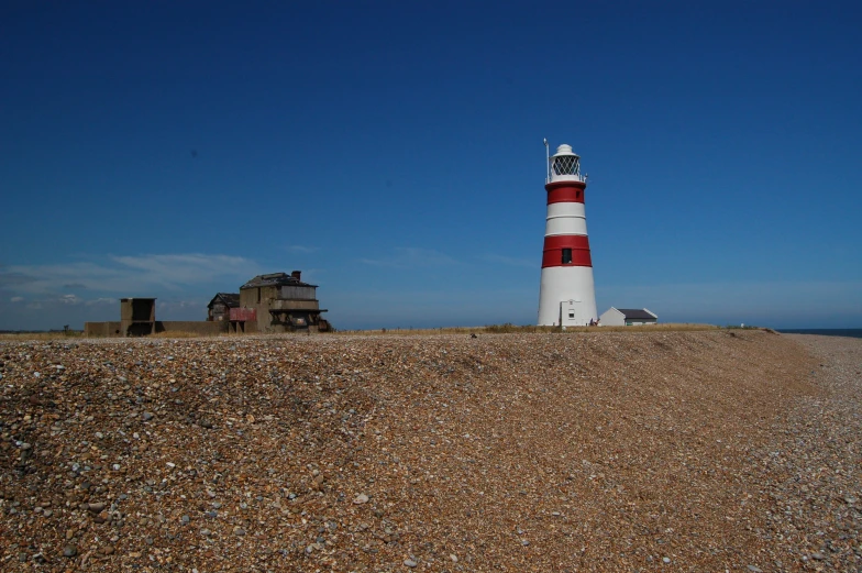 the lighthouse on top of a mountain by the ocean