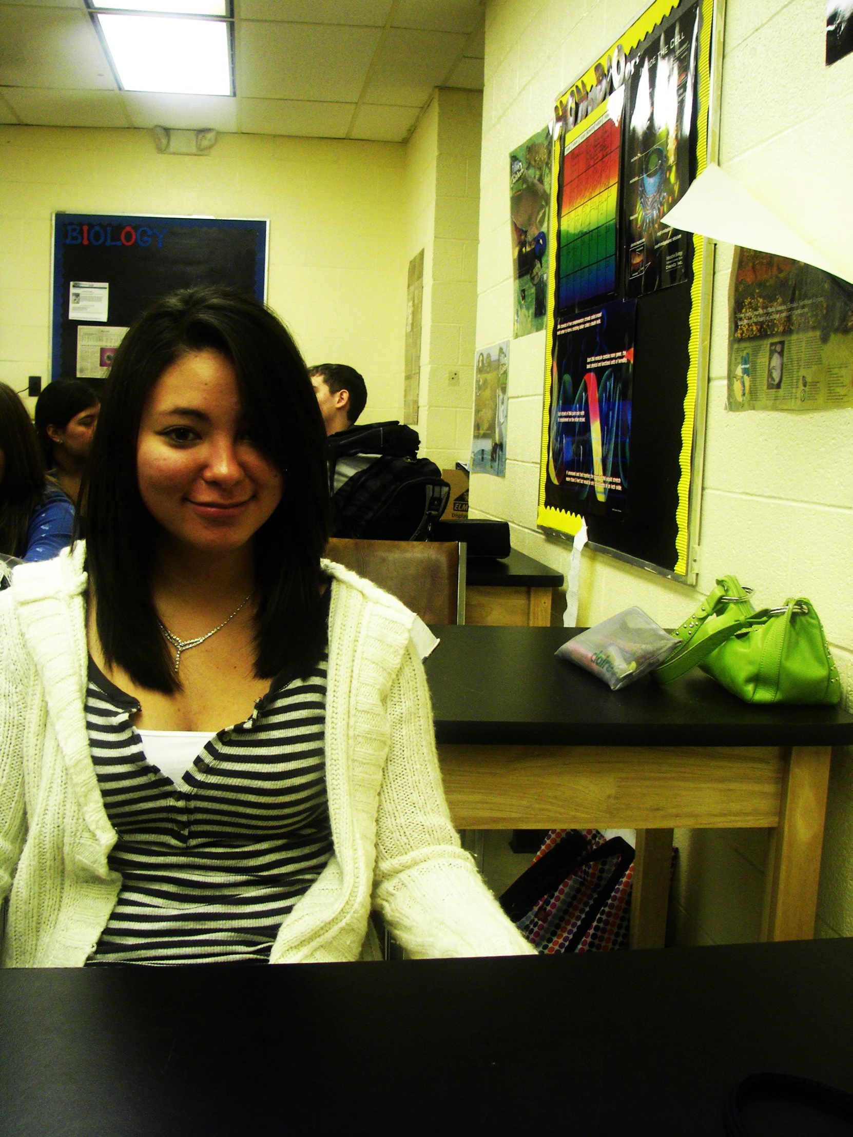 a woman smiles in a classroom setting