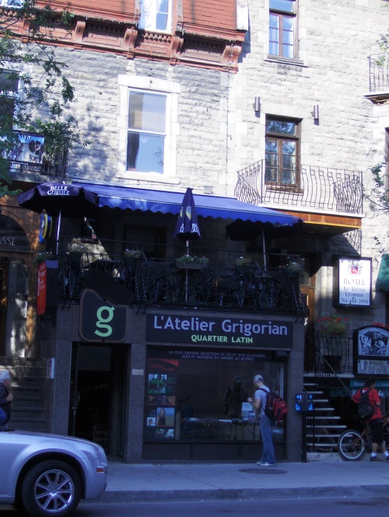 an empty street corner with a building with a blue awning