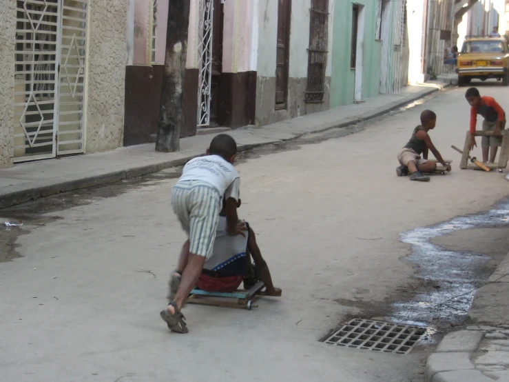 two s and a man playing in the street